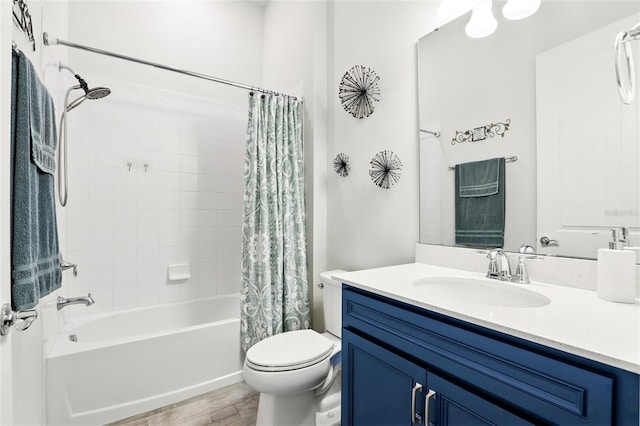 bathroom featuring shower / tub combo, wood finished floors, vanity, and toilet