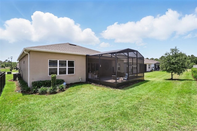 back of property with a lawn, cooling unit, and stucco siding