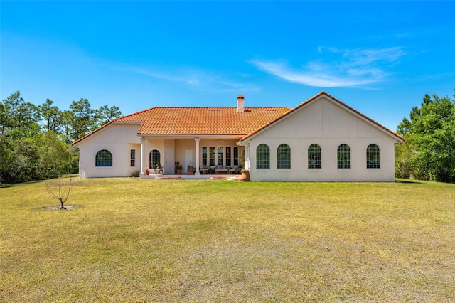 6005 Bancroft Blvd, Orlando, FL 32833 - back of property featuring a tile roof, a chimney, stucco siding, and a lawn