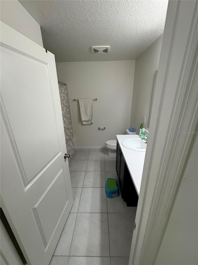 bathroom featuring visible vents, toilet, tile patterned flooring, a textured ceiling, and vanity