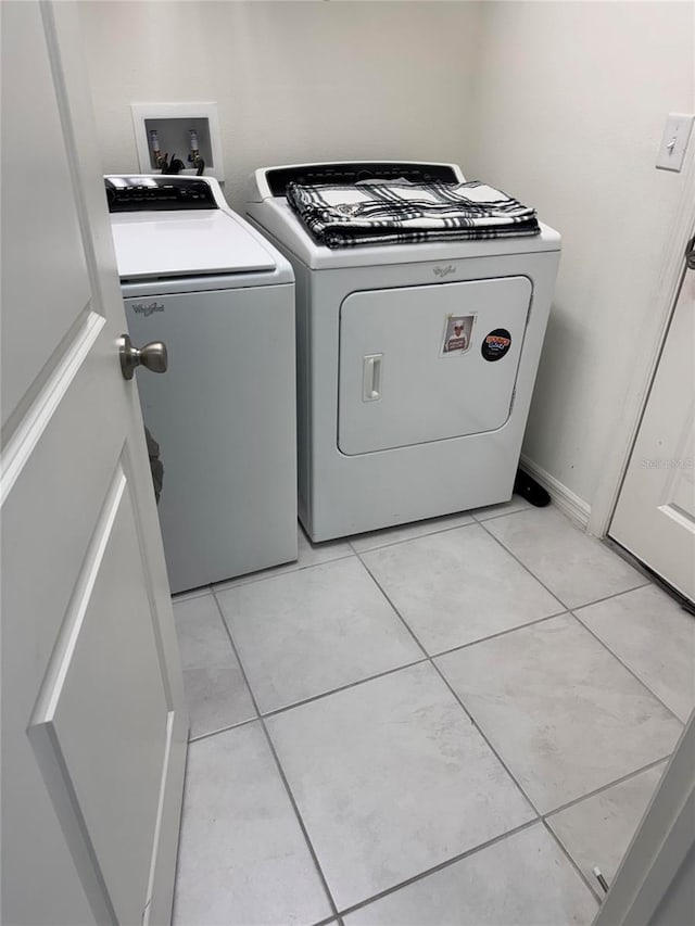 laundry room with light tile patterned floors, laundry area, and washer and dryer