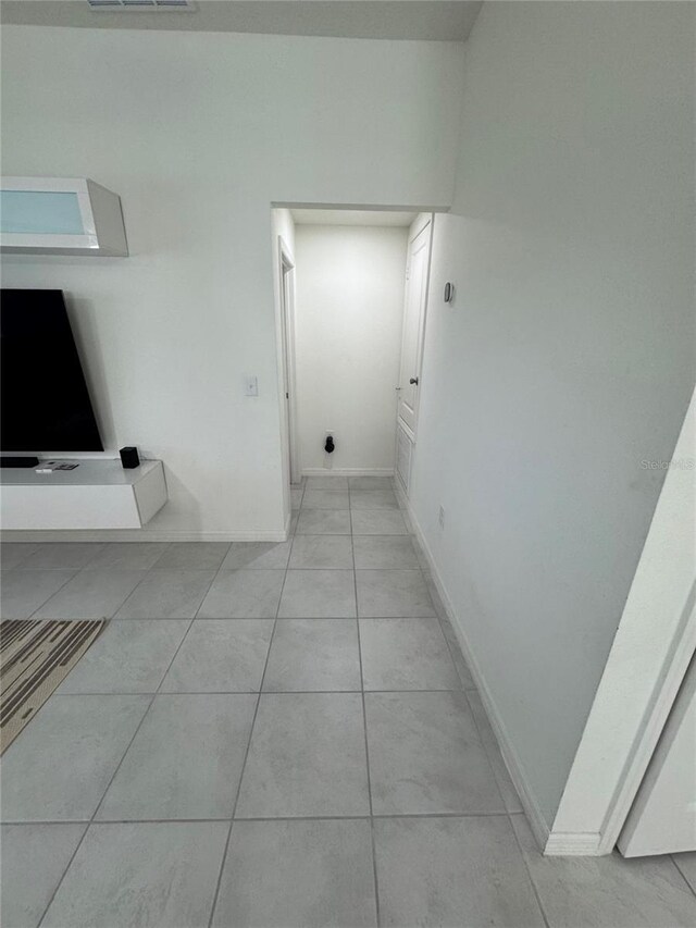 bathroom featuring baseboards, visible vents, and tile patterned floors