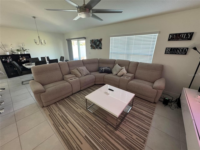 living room with ceiling fan with notable chandelier and light tile patterned flooring