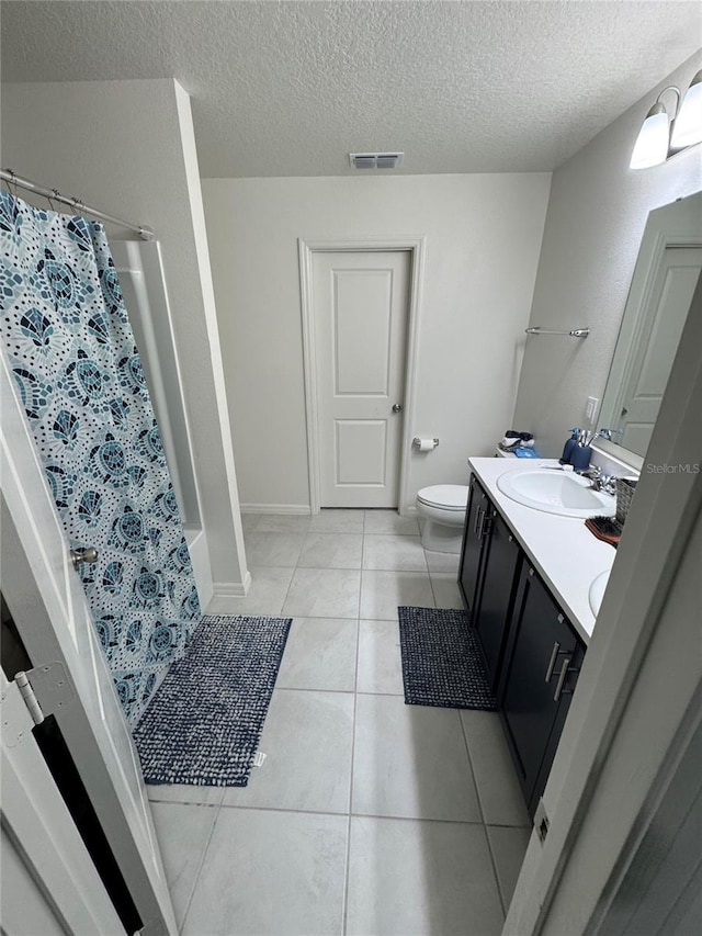 bathroom with curtained shower, tile patterned flooring, visible vents, and vanity