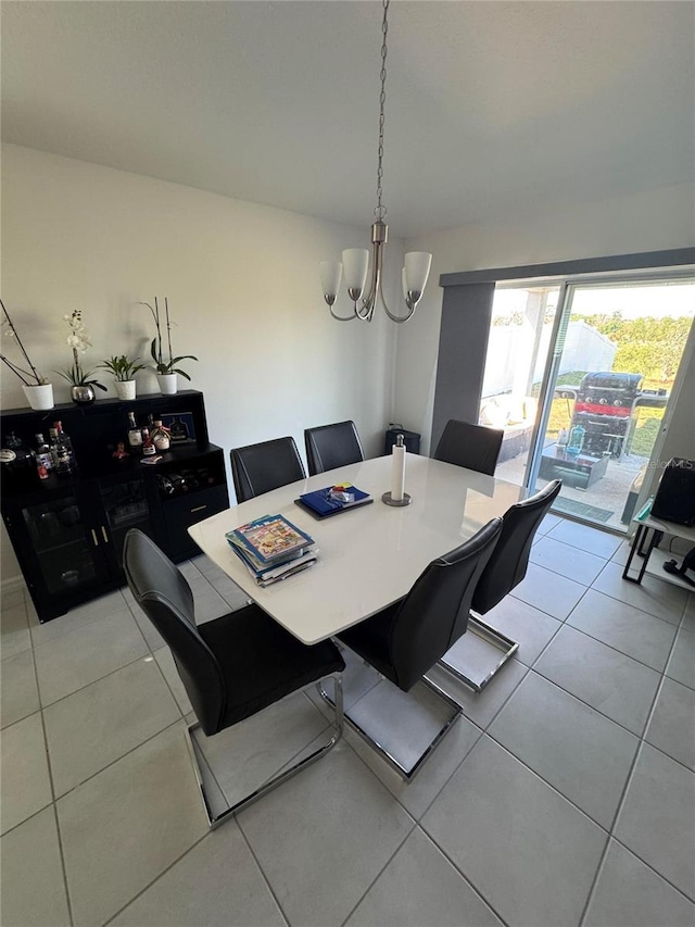 dining area featuring a chandelier and light tile patterned flooring