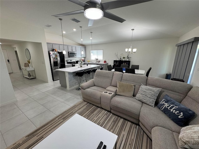 living room featuring vaulted ceiling, light tile patterned floors, ceiling fan with notable chandelier, and visible vents