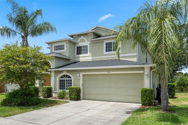 view of front of home with a shingled roof, concrete driveway, a garage, and stucco siding