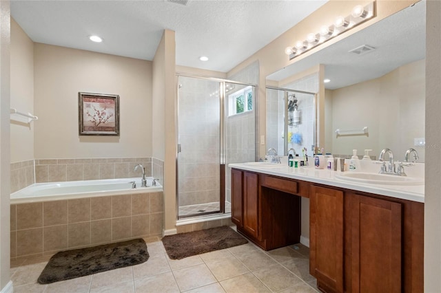 bathroom with tile patterned floors, a stall shower, visible vents, and a sink