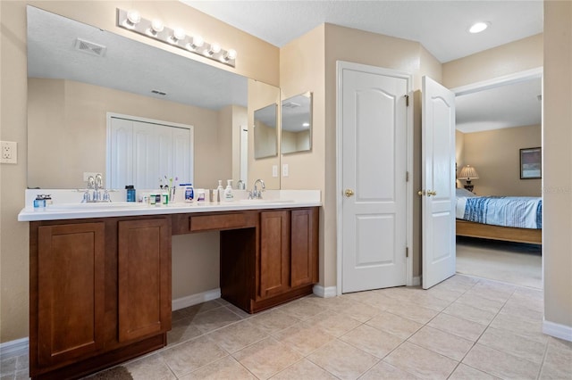 full bathroom with tile patterned floors, ensuite bathroom, and a sink