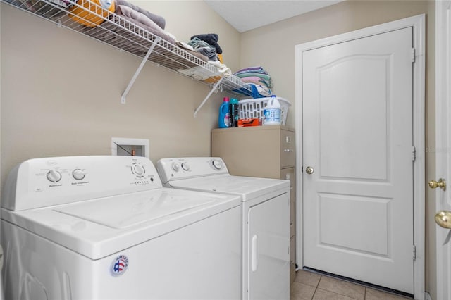 laundry area featuring laundry area, light tile patterned floors, and independent washer and dryer