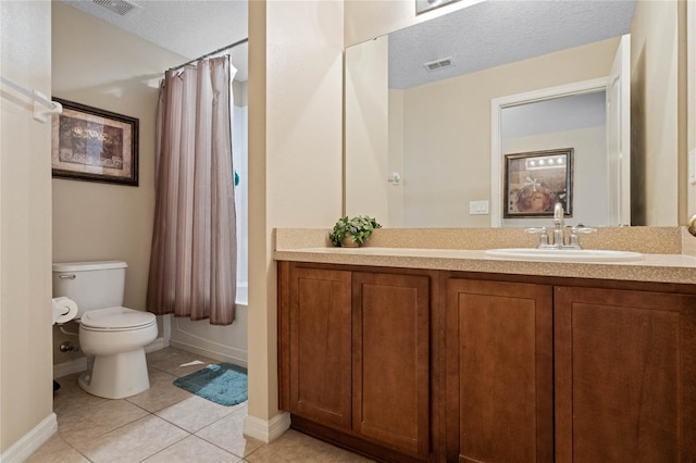 bathroom featuring vanity, tile patterned floors, toilet, and a textured ceiling