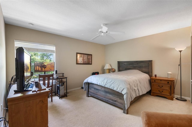 bedroom with light colored carpet and baseboards