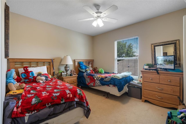 carpeted bedroom with a ceiling fan and a textured ceiling