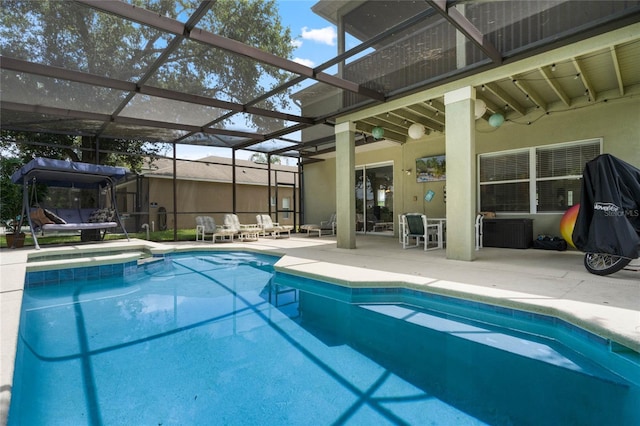 view of swimming pool with a patio area, a lanai, and a pool with connected hot tub