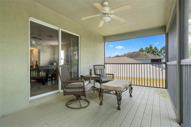 wooden terrace featuring a ceiling fan