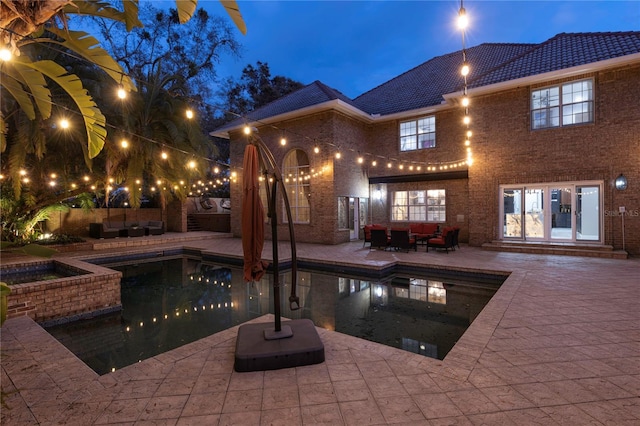 outdoor pool featuring an outdoor living space and a patio