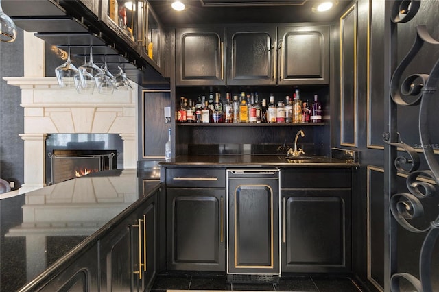 bar featuring wet bar and a high end fireplace