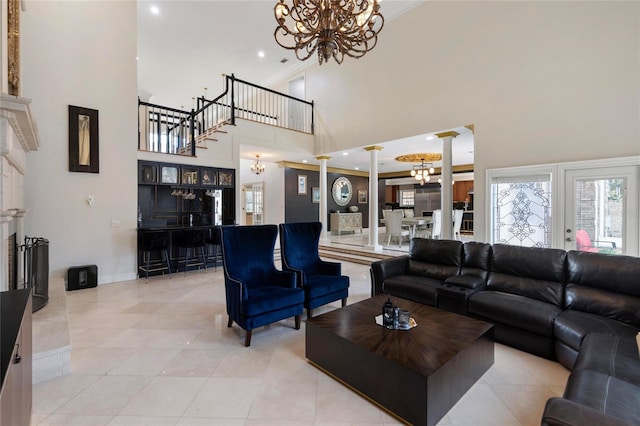 living area featuring ornate columns, an inviting chandelier, light tile patterned flooring, recessed lighting, and a towering ceiling