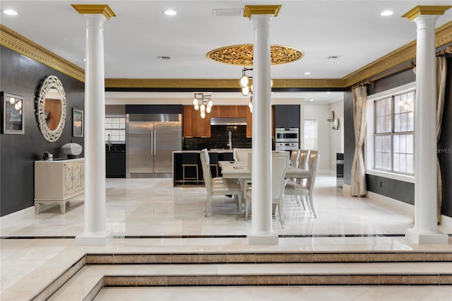 interior space featuring visible vents, ornate columns, baseboards, recessed lighting, and crown molding