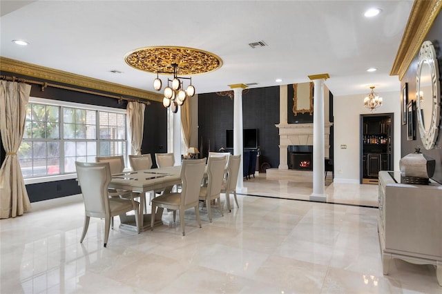 dining area with visible vents, baseboards, decorative columns, a fireplace, and a notable chandelier