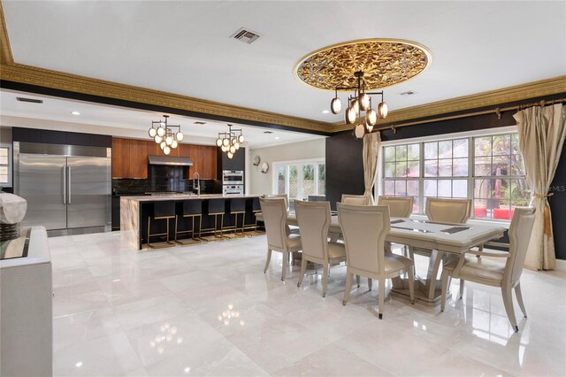 dining area featuring a chandelier, visible vents, and crown molding