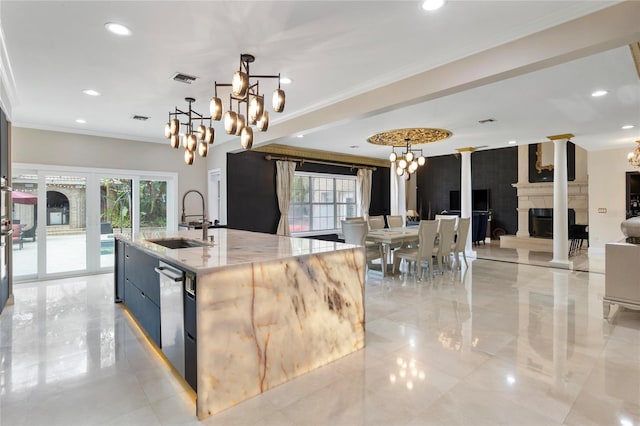 kitchen with light stone countertops, ornamental molding, a sink, decorative light fixtures, and a chandelier