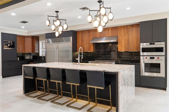 kitchen with a sink, appliances with stainless steel finishes, modern cabinets, and exhaust hood