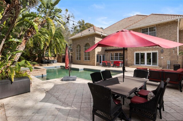 exterior space with a patio area, a jacuzzi, and outdoor lounge area