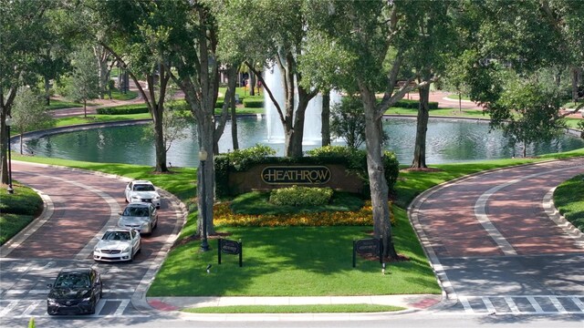 view of property's community with a yard and a water view