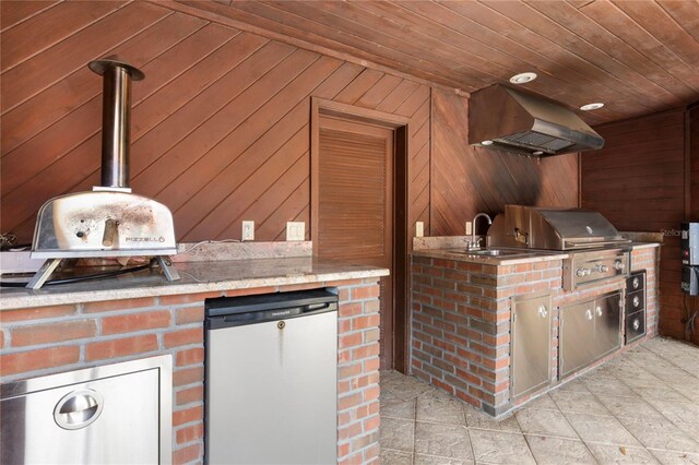 view of patio with area for grilling and a sink