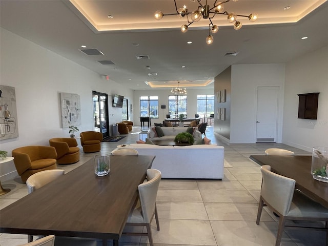 interior space with a chandelier, visible vents, and a tray ceiling