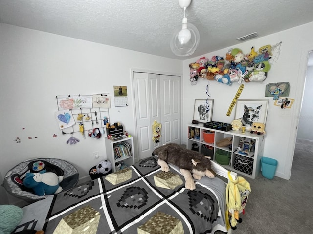 bedroom featuring carpet flooring, visible vents, a closet, and a textured ceiling