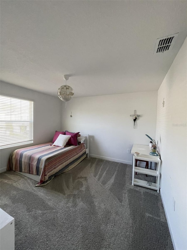 unfurnished bedroom with visible vents, baseboards, and carpet