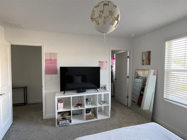 bedroom with baseboards and carpet