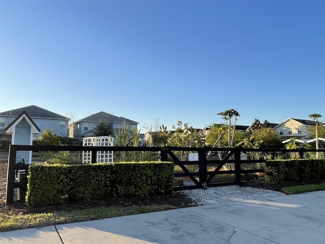 view of gate with a residential view and fence