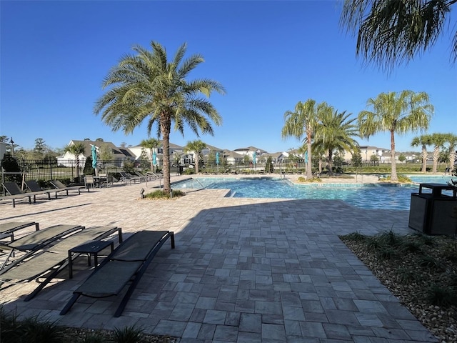 community pool featuring a patio area and fence