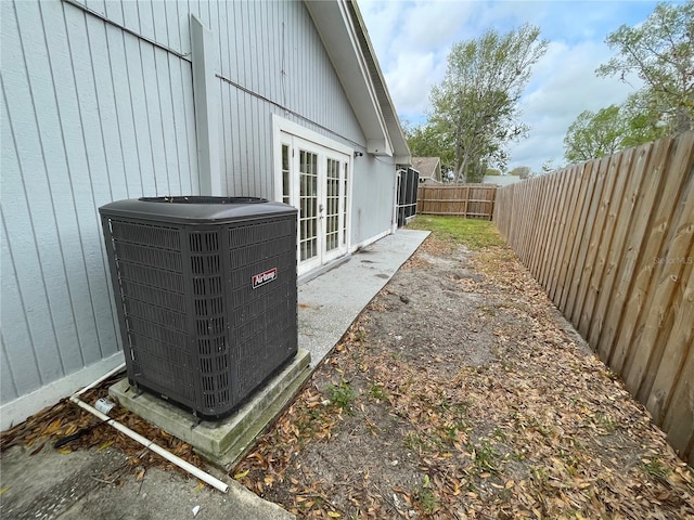 details featuring french doors, a fenced backyard, and central air condition unit