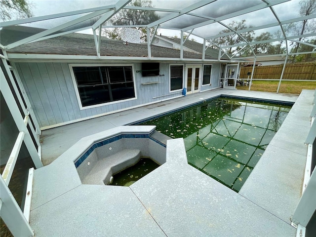 view of swimming pool featuring a fenced in pool, a patio, an in ground hot tub, a lanai, and fence