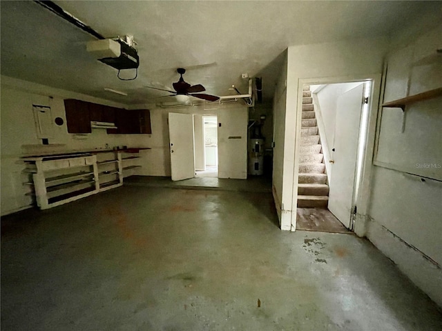garage featuring water heater and a garage door opener