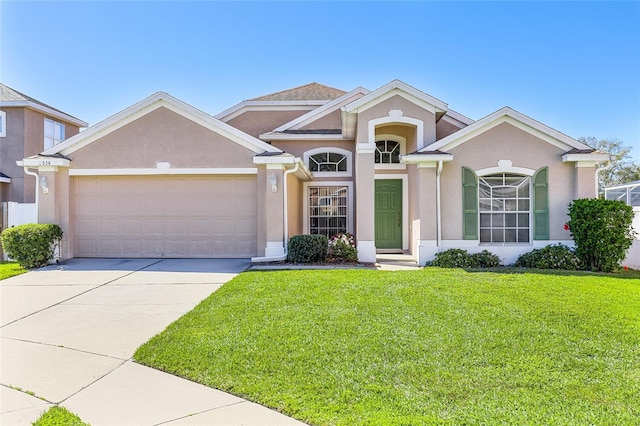 view of front facade featuring an attached garage, driveway, a front lawn, and stucco siding