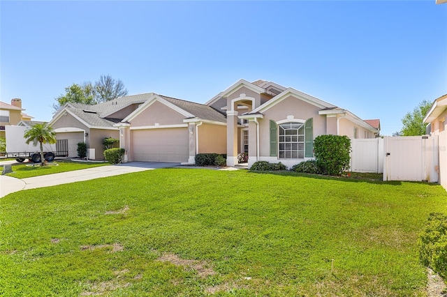 view of front of house featuring an attached garage, concrete driveway, a gate, stucco siding, and a front yard