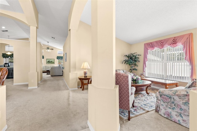 carpeted living room featuring arched walkways, ceiling fan, lofted ceiling, and baseboards