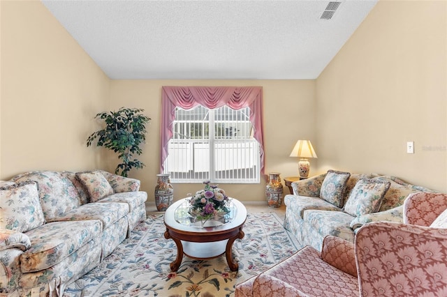 living room featuring a textured ceiling, carpet floors, visible vents, and baseboards