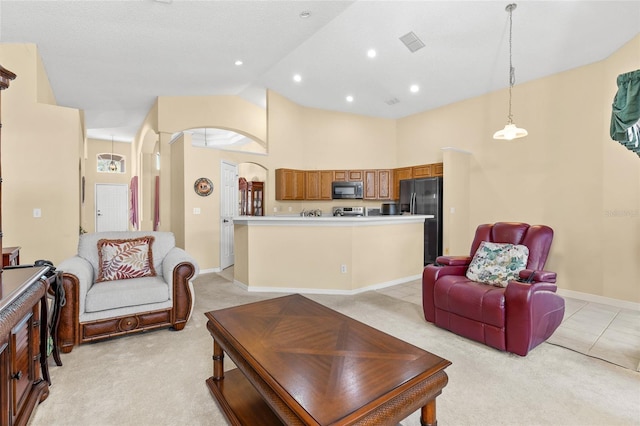 living area featuring light carpet, baseboards, visible vents, high vaulted ceiling, and recessed lighting