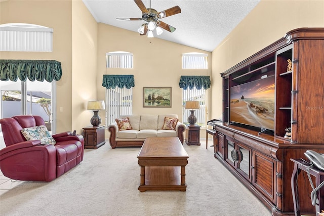 living area featuring a textured ceiling, ceiling fan, carpet, and high vaulted ceiling