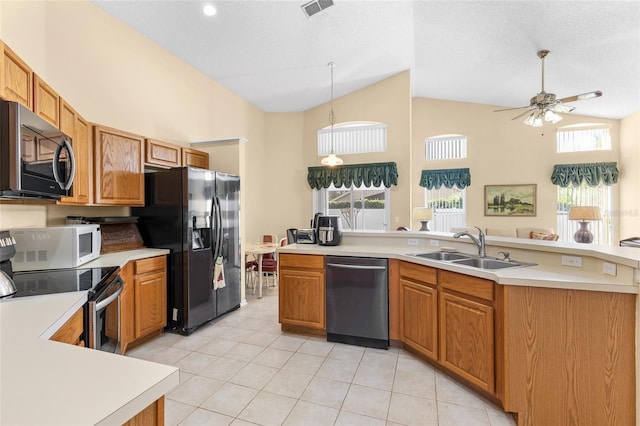 kitchen with light tile patterned floors, ceiling fan, appliances with stainless steel finishes, light countertops, and a sink