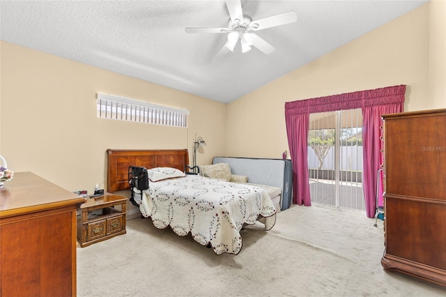 bedroom featuring access to exterior, lofted ceiling, a textured ceiling, and carpet