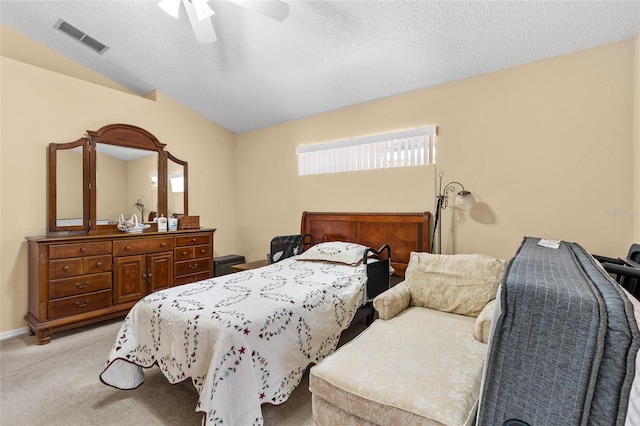 bedroom with a textured ceiling, light colored carpet, a ceiling fan, baseboards, and visible vents