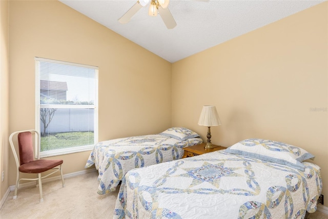 carpeted bedroom featuring lofted ceiling, a ceiling fan, and baseboards