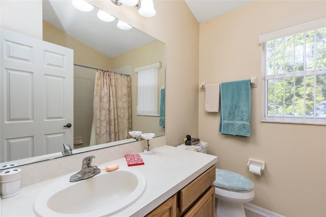 full bathroom with a healthy amount of sunlight, curtained shower, toilet, and vanity